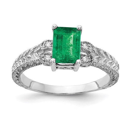 14k white gold emerald cut emerald and AA diamond ring, showcasing a 7x5mm gemstone and sparkling accents.