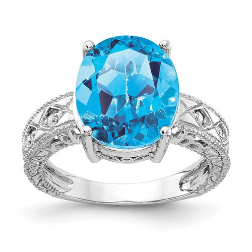 14k white gold ring with a 12x10mm oval blue topaz and AA diamonds, elegant jewelry piece from Solomon Jewelers.