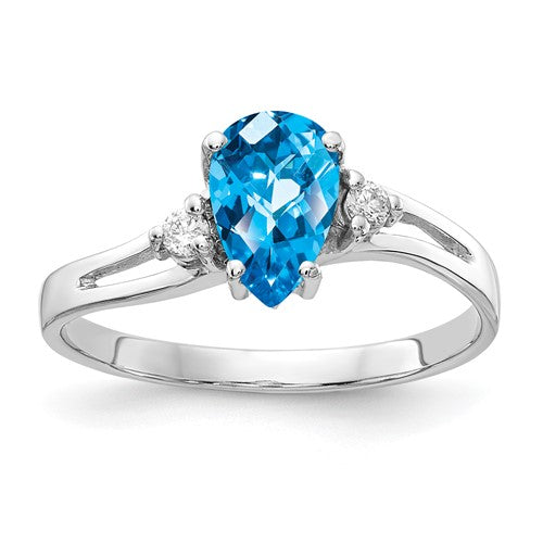 14k white gold ring with a 7x5mm pear-shaped blue topaz and AA diamond accents, featuring a checker design.