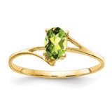 14k gold oval peridot ring with 6x4mm gemstone, elegant jewelry piece featuring a vibrant green peridot stone.