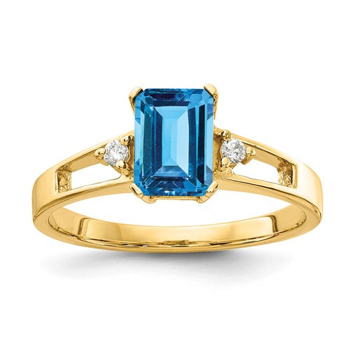 14k gold ring featuring a 7x5mm emerald cut blue topaz gemstone with diamond accents, crafted by Solomon Jewelers.