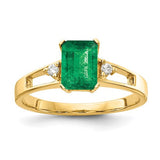 14k gold emerald cut emerald and AA diamond ring featuring a 7x5mm gemstone, designed by Solomon Jewelers.