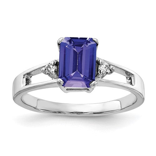 14k white gold ring with a 7x5mm emerald cut tanzanite and AA diamond accents, elegant jewelry piece.
