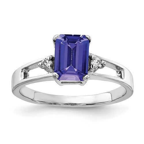 14k white gold ring with a 7x5mm emerald cut tanzanite and AA diamond accents, elegant jewelry piece.