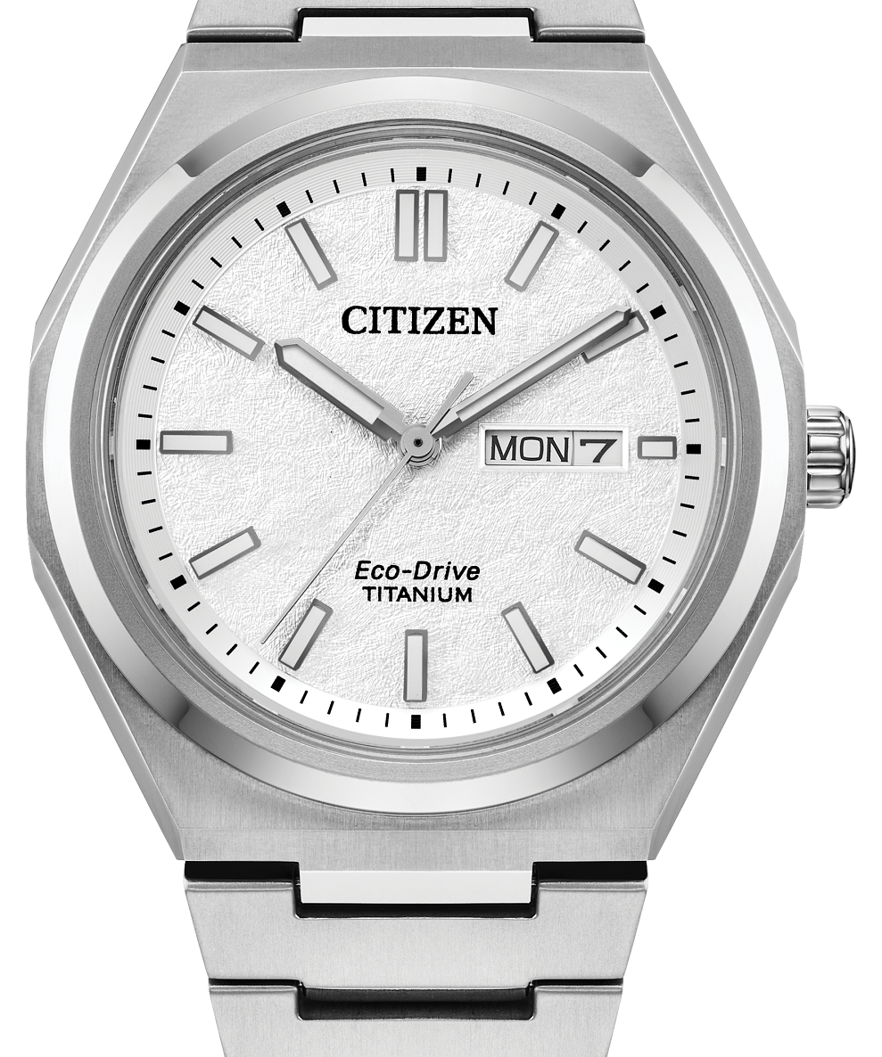 Citizen Eco-Drive Titanium watch with a silver stainless steel case and link bracelet, featuring a white textured dial with silver indices and a day-date window.