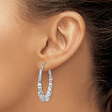 14K white gold bamboo hoop earrings with a sleek, polished finish, showcasing elegant jewelry design.