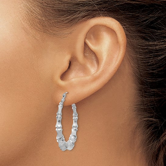 14K white gold bamboo hoop earrings with a sleek, polished finish, showcasing elegant jewelry design.