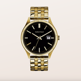 A luxury men's watch by Caravelle, featuring a gold-tone metal link bracelet, a fluted bezel, and a black dial with gold-tone indices and hands.