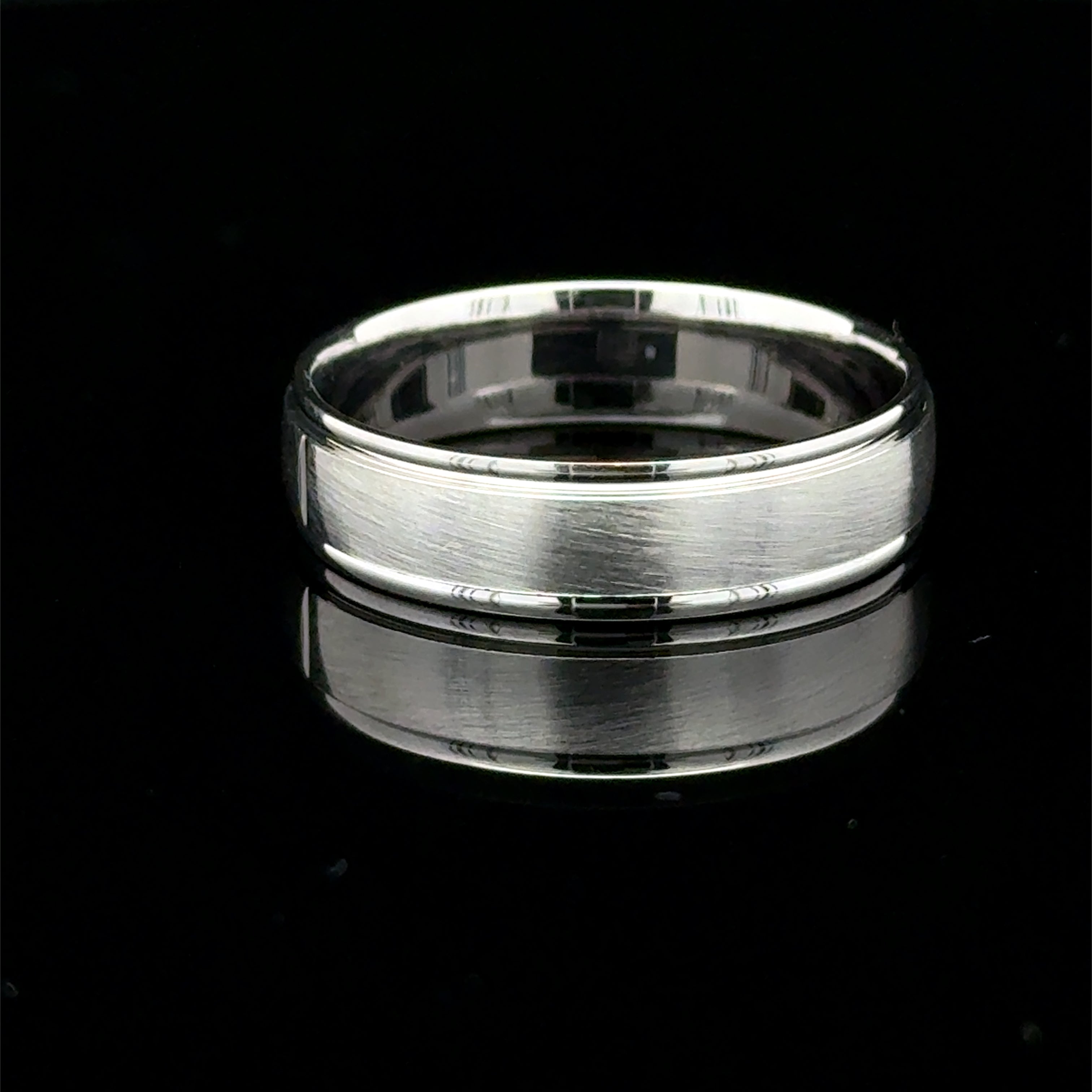 Brushed white gold men’s wedding band with polished raised edges available at Solomon Jewelers.