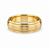 Brushed yellow gold men’s wedding band with polished rails and milgrain edges on a white background