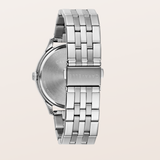 Silver stainless steel watch with a multi-link bracelet, shown from the back on a light beige background. The brand name 'CARAVELLE' is engraved on the clasp and case back.