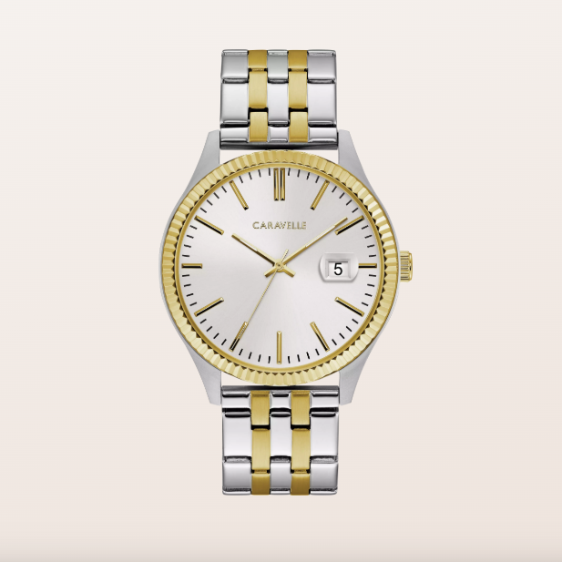A Caravelli men's watch featuring a two-tone silver and gold stainless steel link bracelet, a gold-tone fluted bezel, and a white dial with gold hands and a date window.