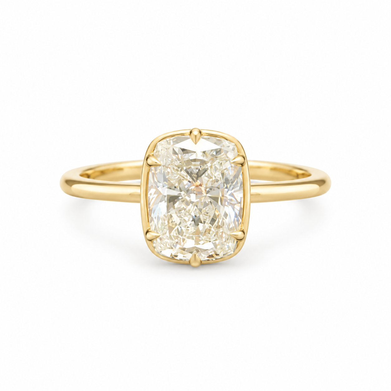 Elongated diamond solitaire ring with softly rounded corners, six prongs and a slim polished gold-toned band