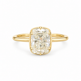Elongated diamond solitaire ring with softly rounded corners, six prongs and a slim polished gold-toned band