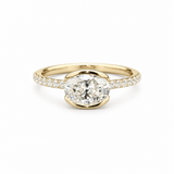 A yellow gold engagement ring featuring a large oval-cut center stone in a prong setting, with a pavé band set with small round stones, shown on a plain white background.