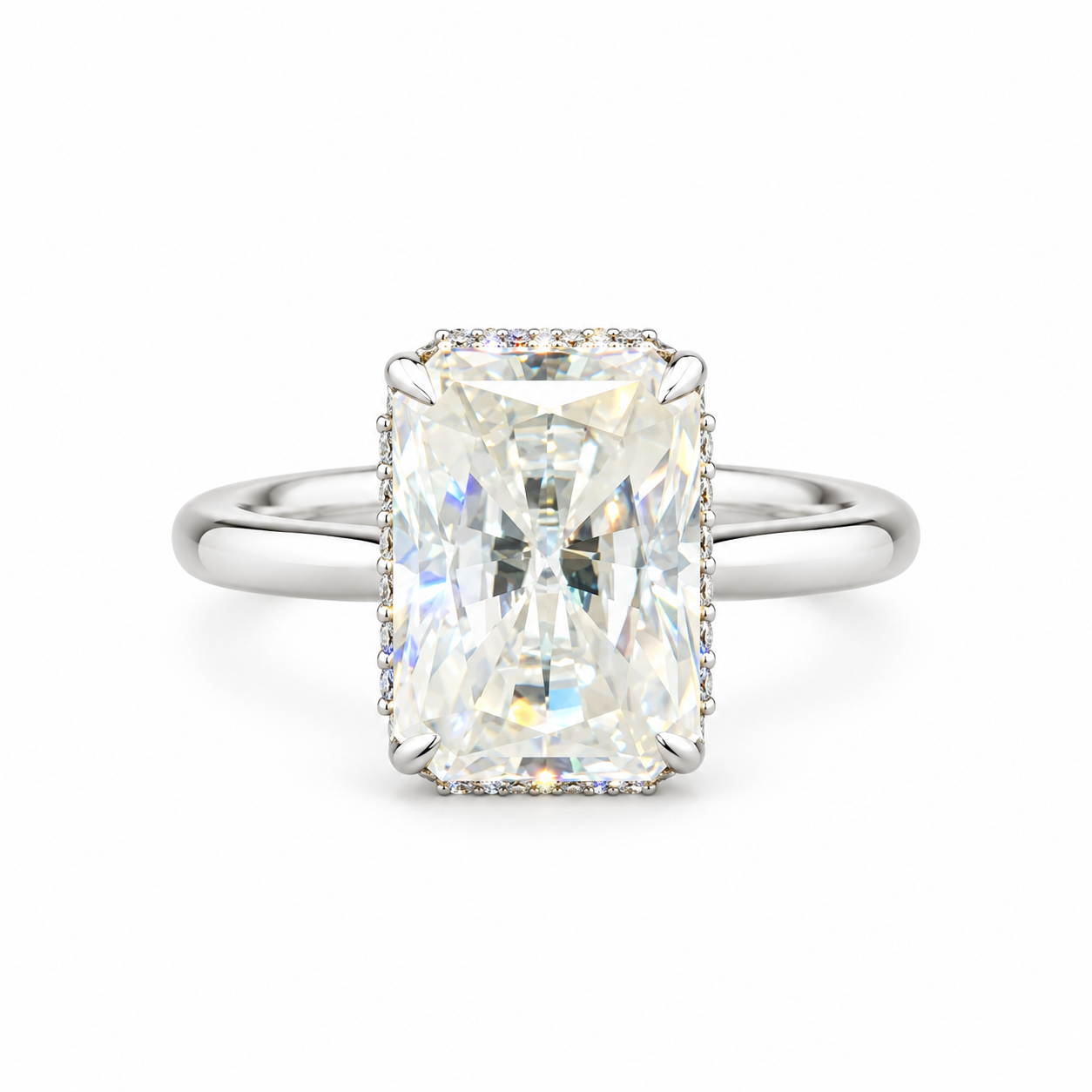 An emerald-cut diamond ring with a silver-toned band and a halo of small diamonds, centered on a plain white background.