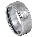 A silver-toned metal band ring with a brushed outer surface and a faceted, hammered texture on the top, shown on a plain white background.