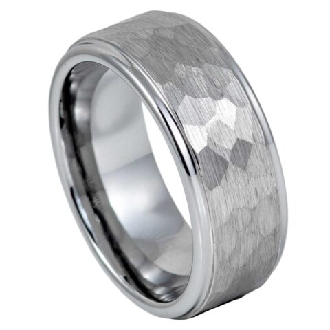 A silver-toned metal band ring with a brushed outer surface and a faceted, hammered texture on the top, shown on a plain white background.