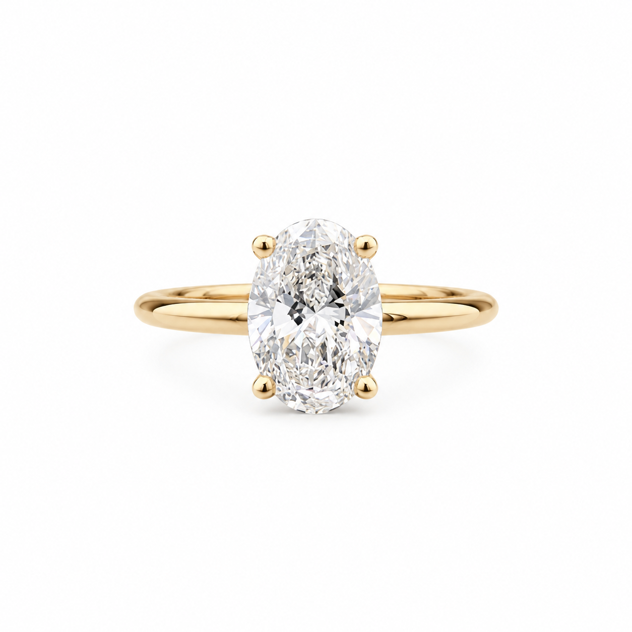 An oval-cut diamond engagement ring with a yellow gold band, set against a clean white background.