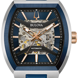 Bulova automatic watch with a blue silicone strap, brushed stainless steel case, and a skeleton dial showing the inner mechanical movement.