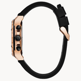 Close-up of a watch with a black strap and rose gold case.