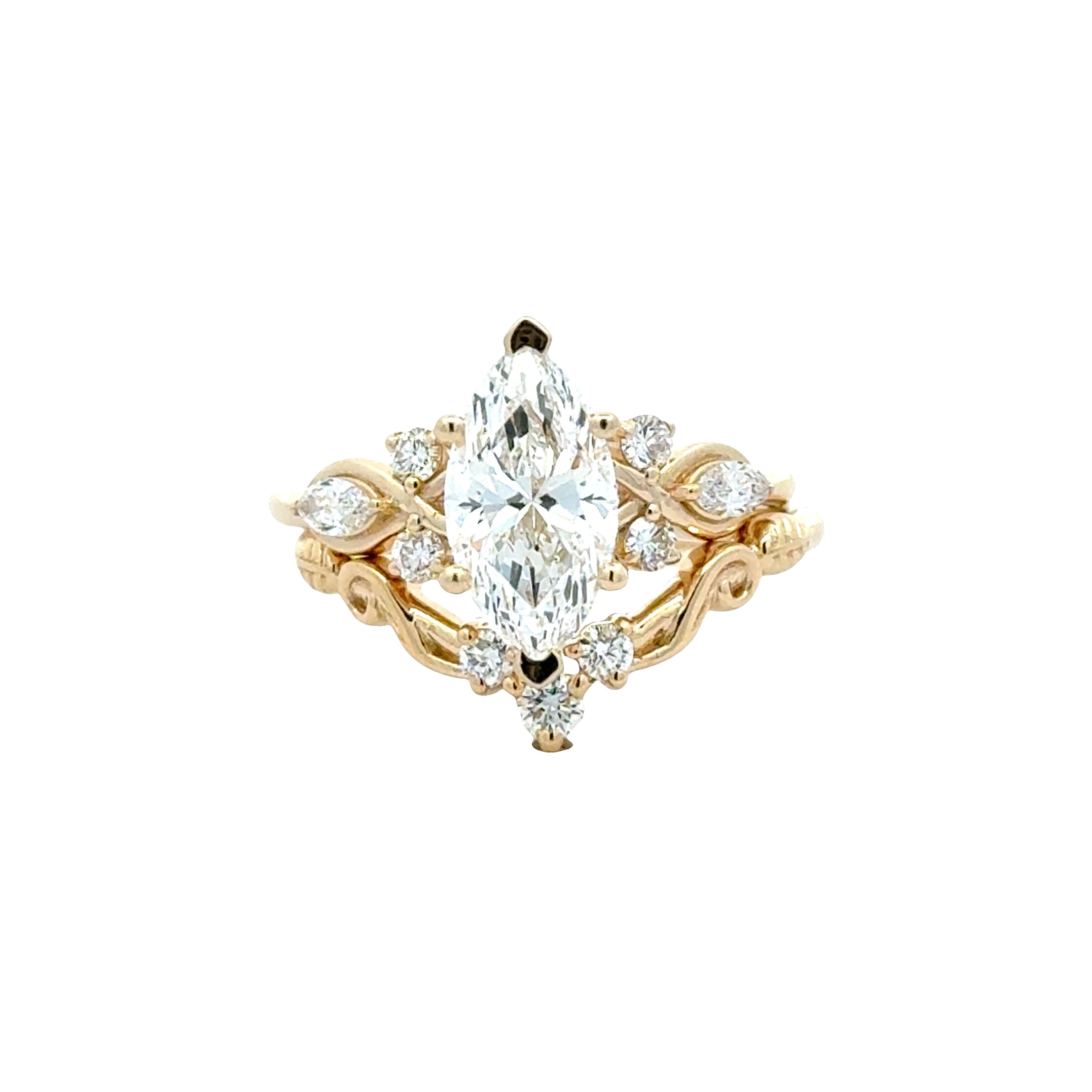 Marquise cut lab grown diamond bridal ring set in yellow gold with leaf-shaped diamond accents and a fitted contour wedding band.