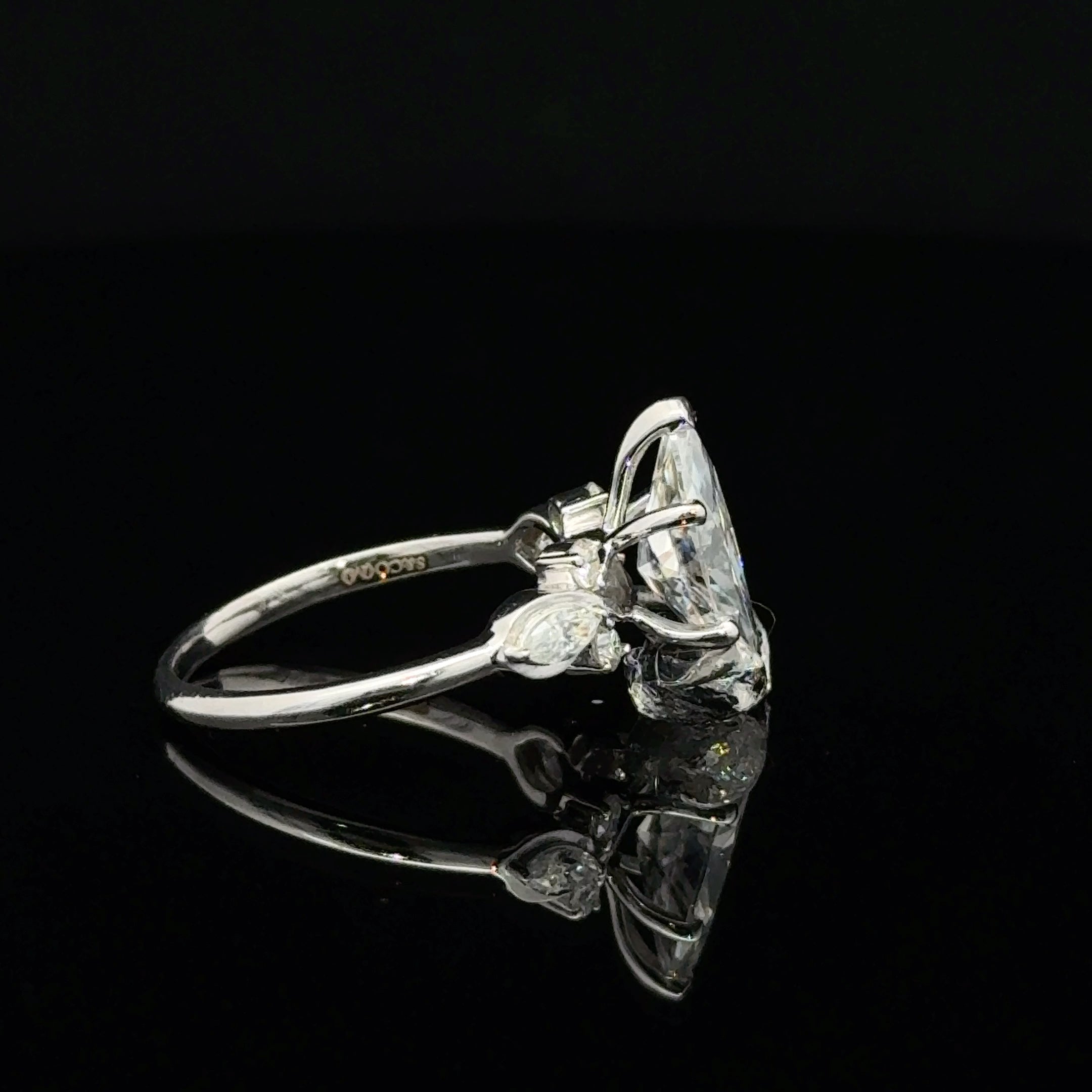 Discover a marquise moissanite silver ring with flowing leaf details and round side accents. Explore nature-inspired jewelry at Solomon & Co.