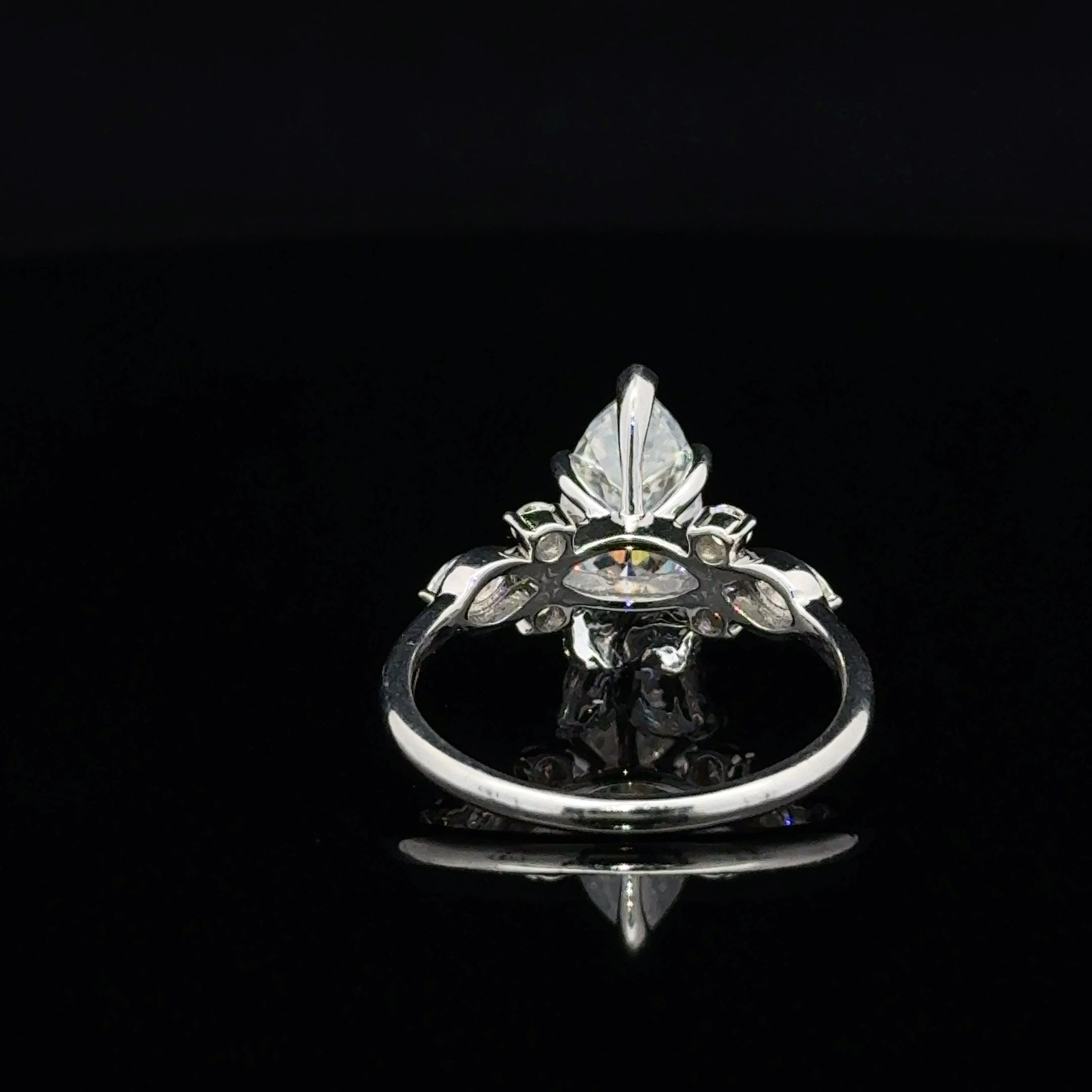 Discover a marquise moissanite silver ring with flowing leaf details and round side accents. Explore nature-inspired jewelry at Solomon & Co.