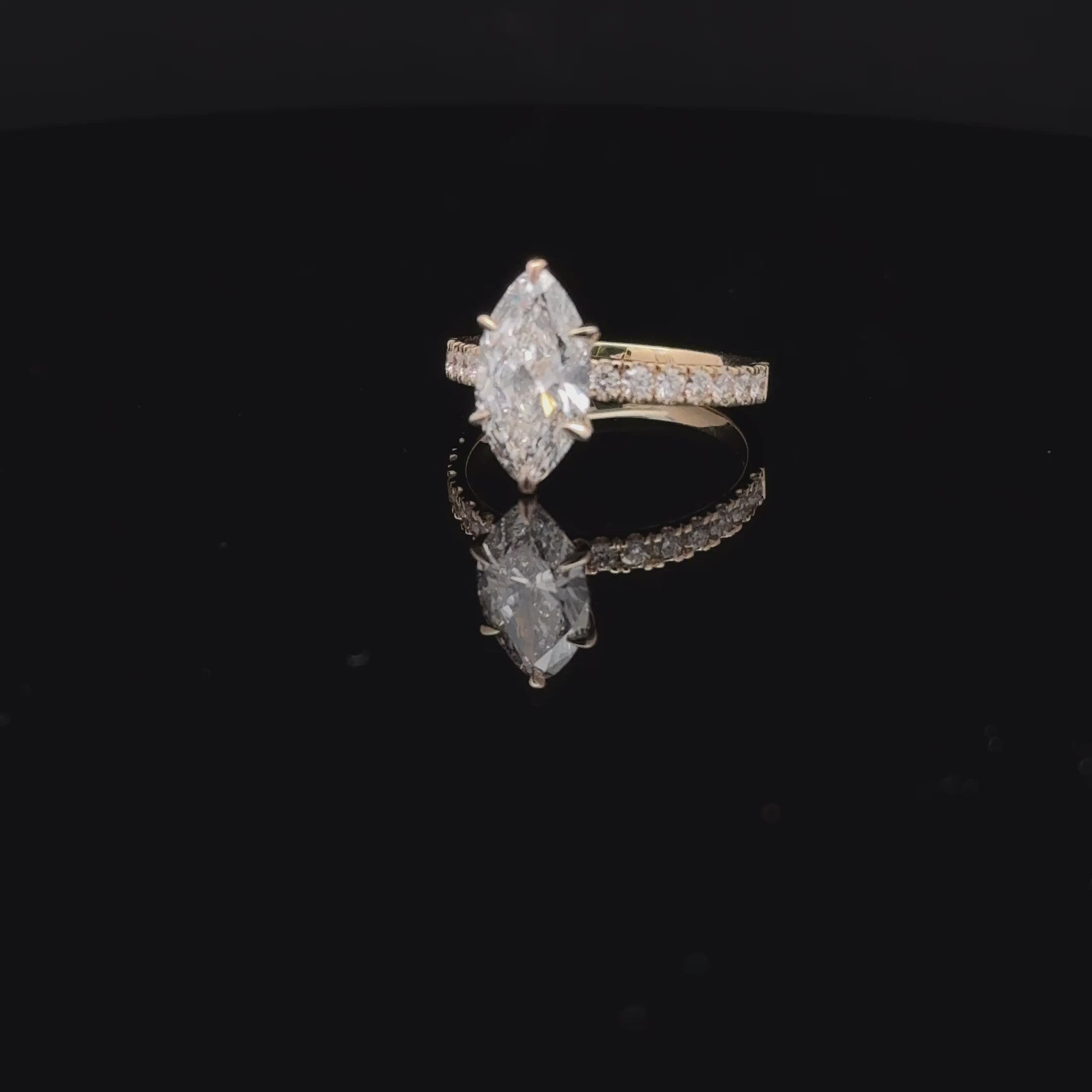 14K white gold solitaire ring with a marquise-cut lab-grown diamond, six-prong setting, and diamond-accented band.