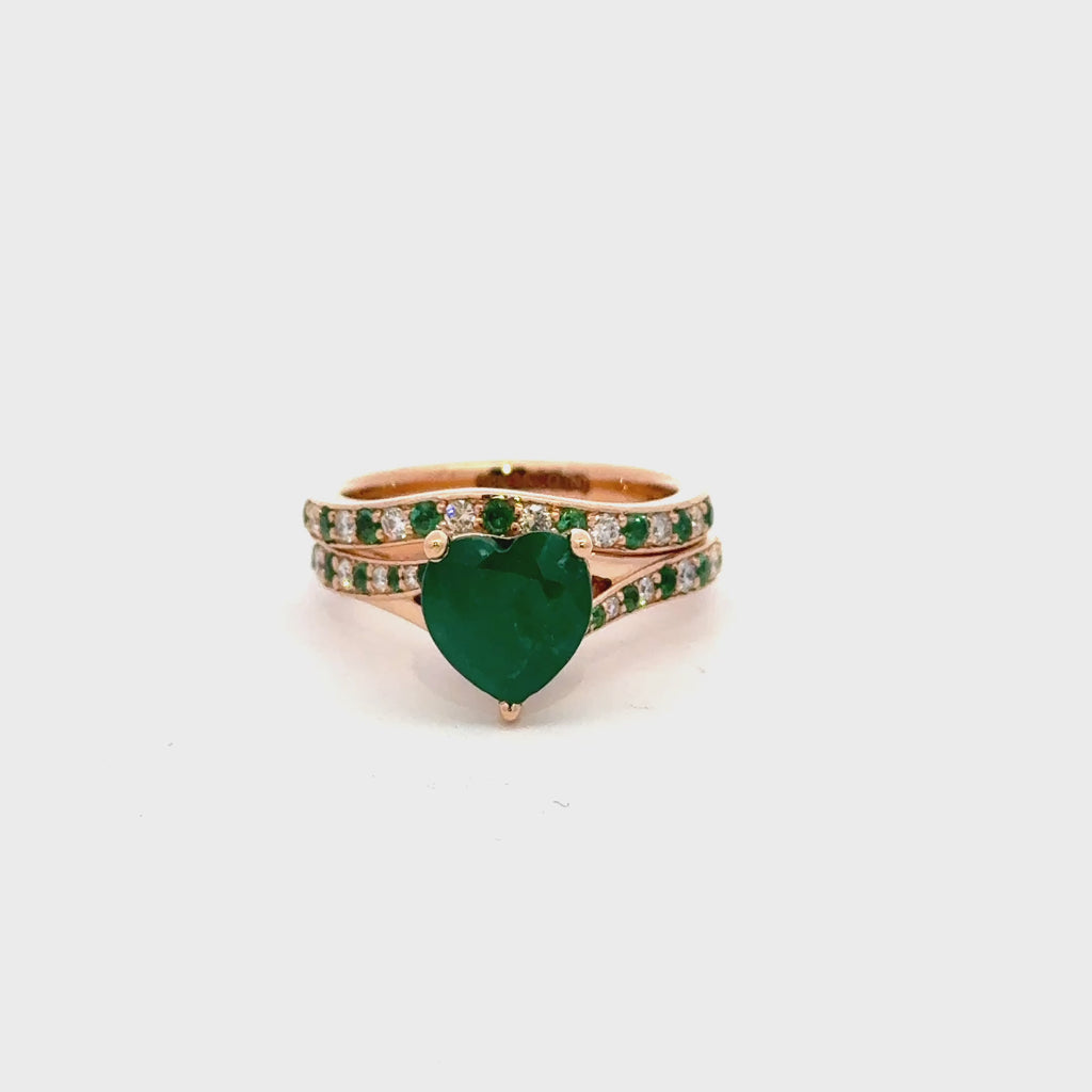 18Karat gold with heart shaped natural emerald and diamond bridal ring with alternate emerald in band.