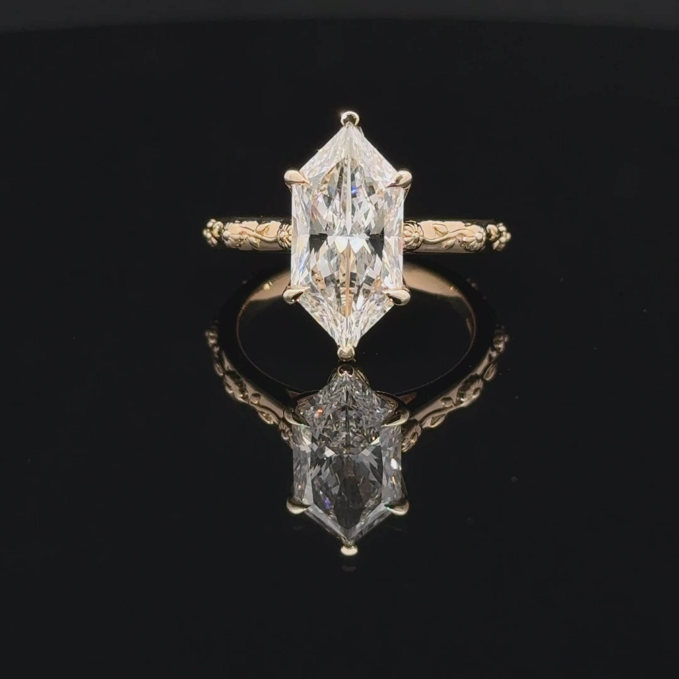 14K yellow gold ring featuring a Dutch marquise-cut lab-grown diamond in a six-prong setting with floral engraving and diamond accents with tulip basket.