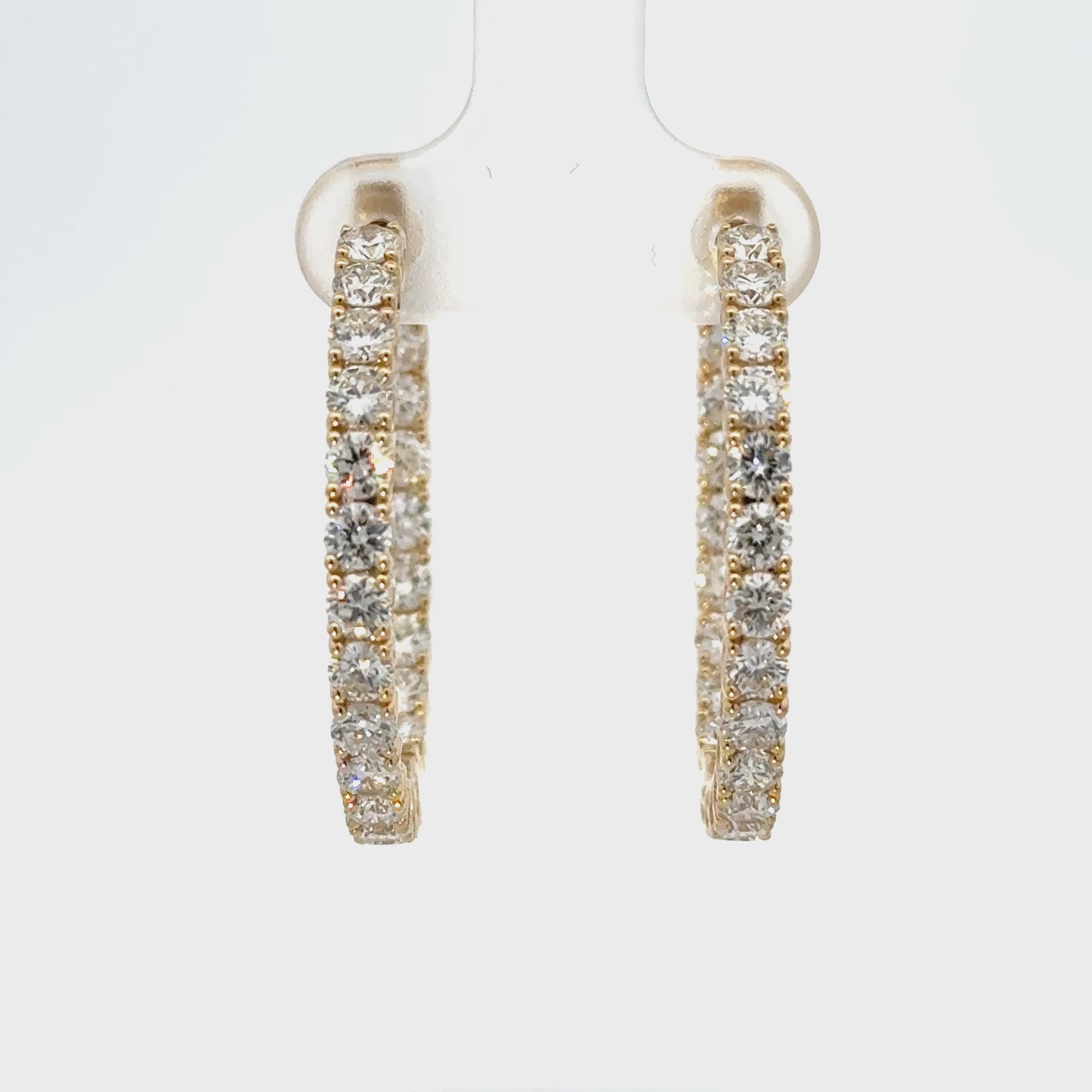 10K yellow gold inside-out diamond hoop earrings with round brilliant diamonds and hinged closure.