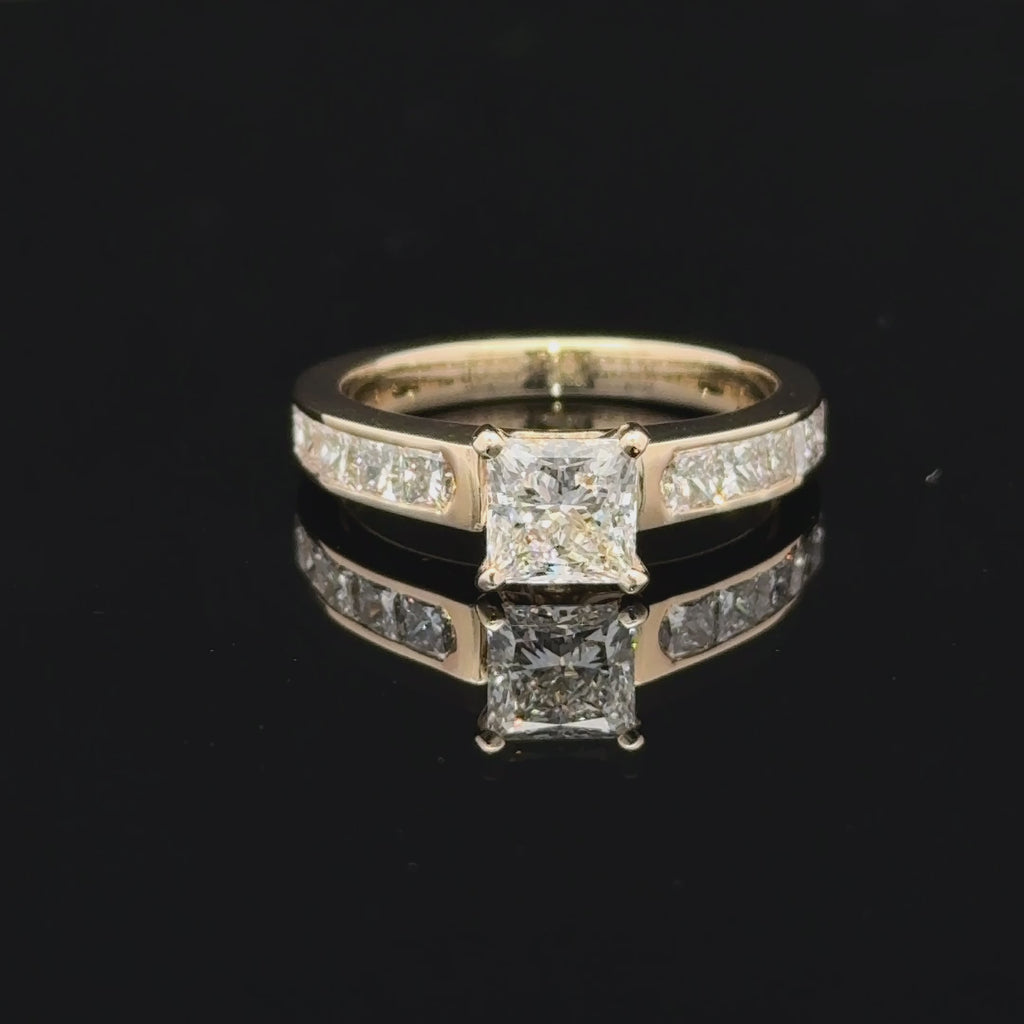 14K yellow gold ring with a 1-carat princess-cut lab-grown diamond and channel-set princess diamond accents on a white background