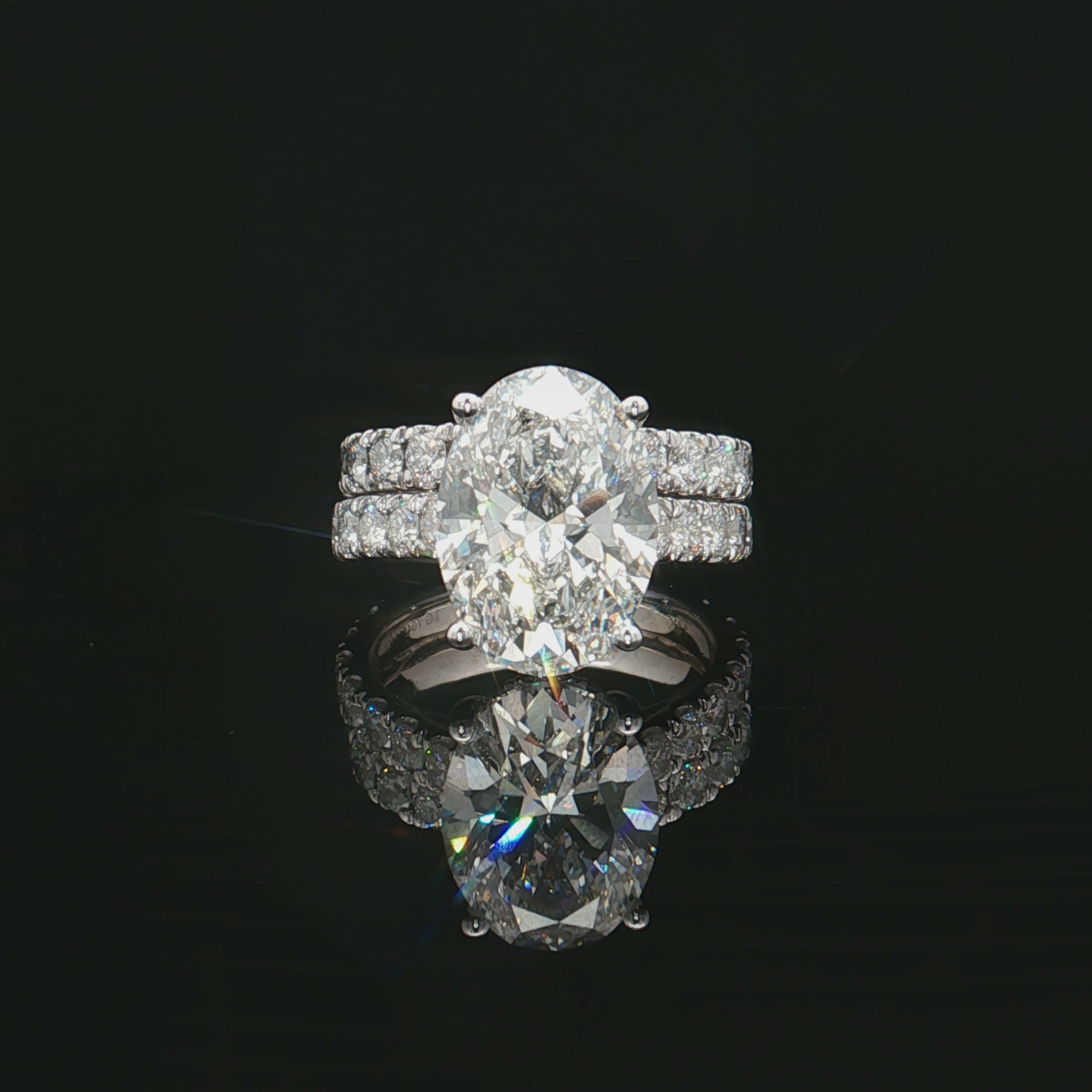 Oval Solitaire Engagement Ring Set in a Cathedral Setting with hidden halo and pave band - Solomon Jeweler