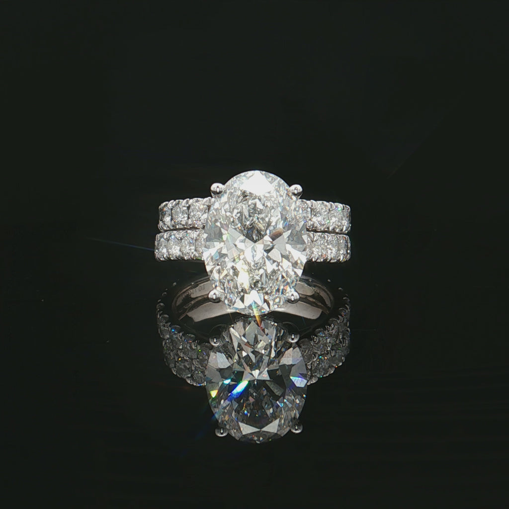 Oval Solitaire Engagement Ring Set in a Cathedral Setting with hidden halo and pave band - Solomon Jeweler