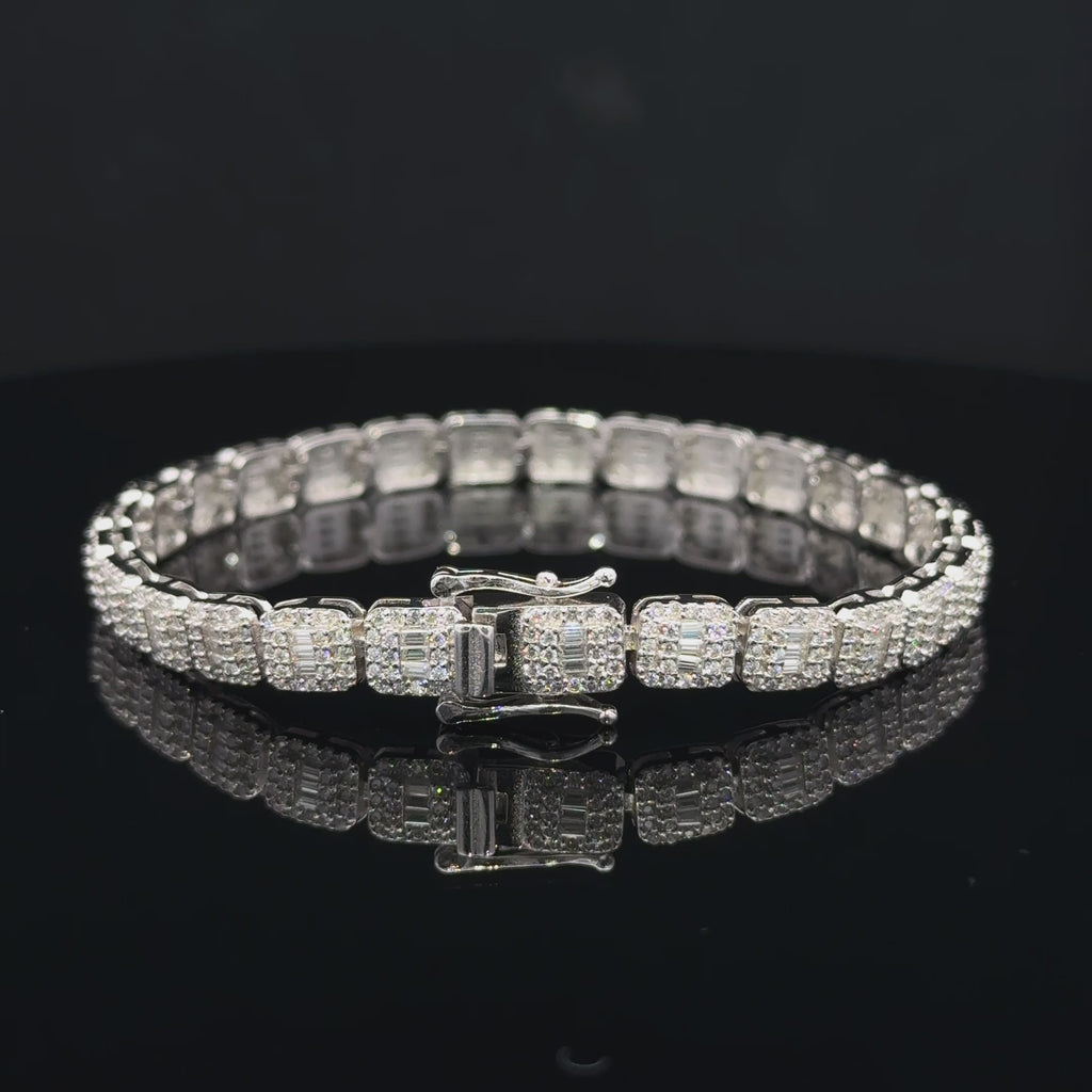 Silver moissanite bracelet with rounded square links, baguette-style centers, round accent stones and a box clasp.