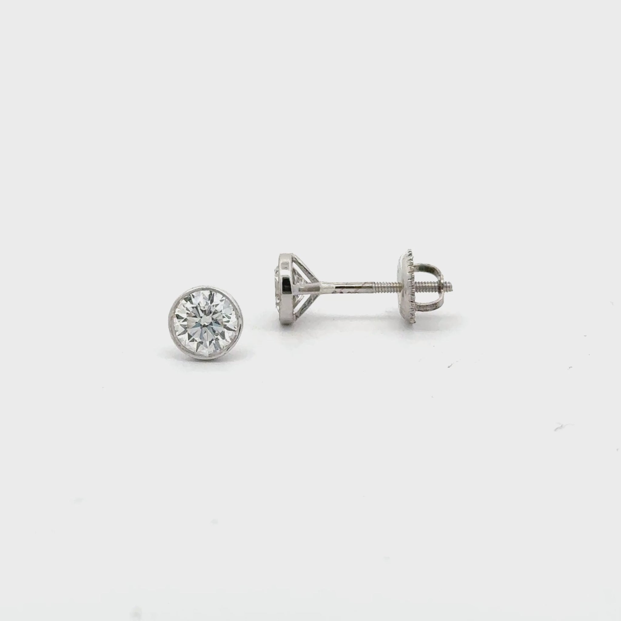 Video of 14K yellow gold bezel-set lab diamond stud earrings with screw backs – Solomon Jeweler.