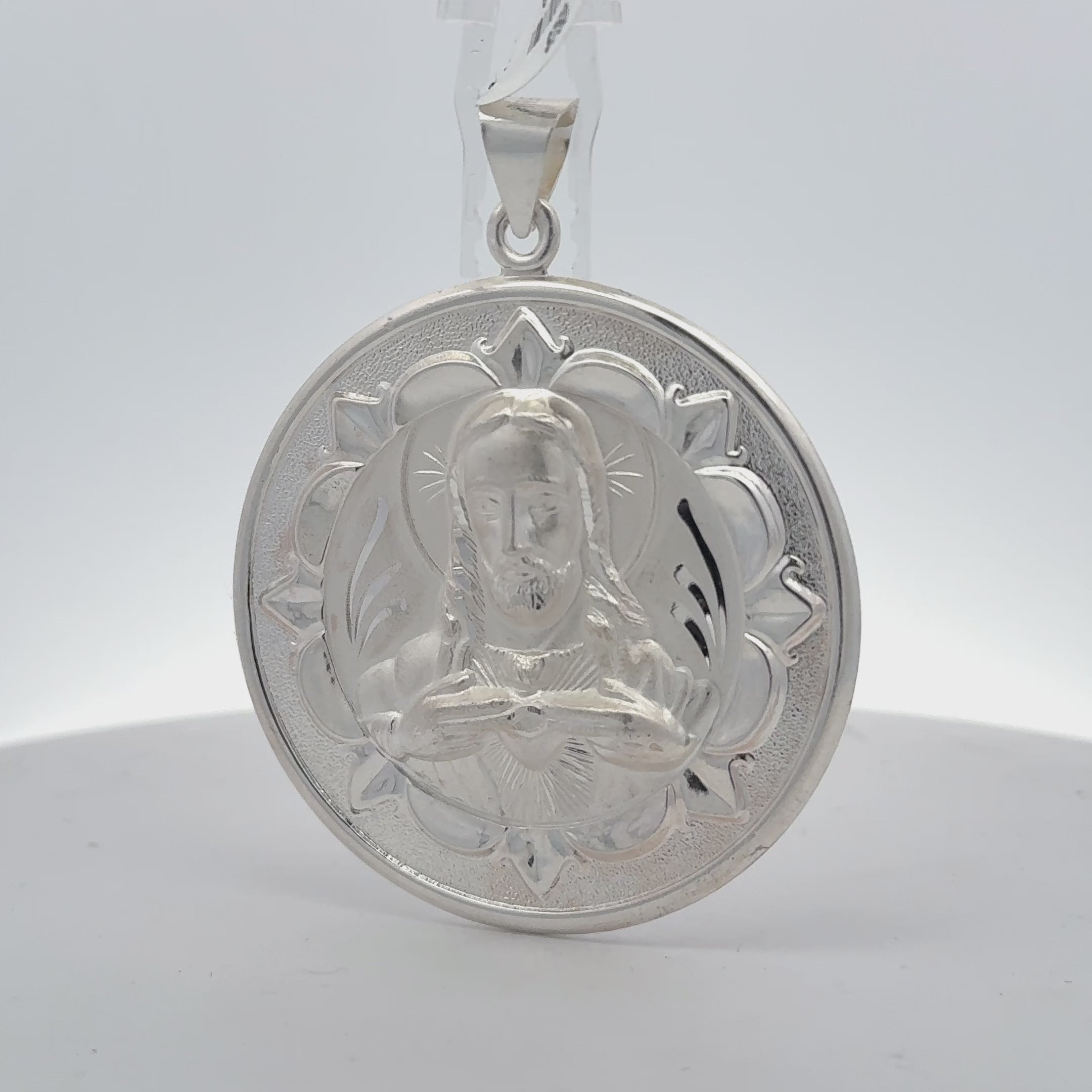 sterling silver double-sided Jesus and Virgin Mary medallion pendant showing Jesus with the Sacred Heart and a floral border