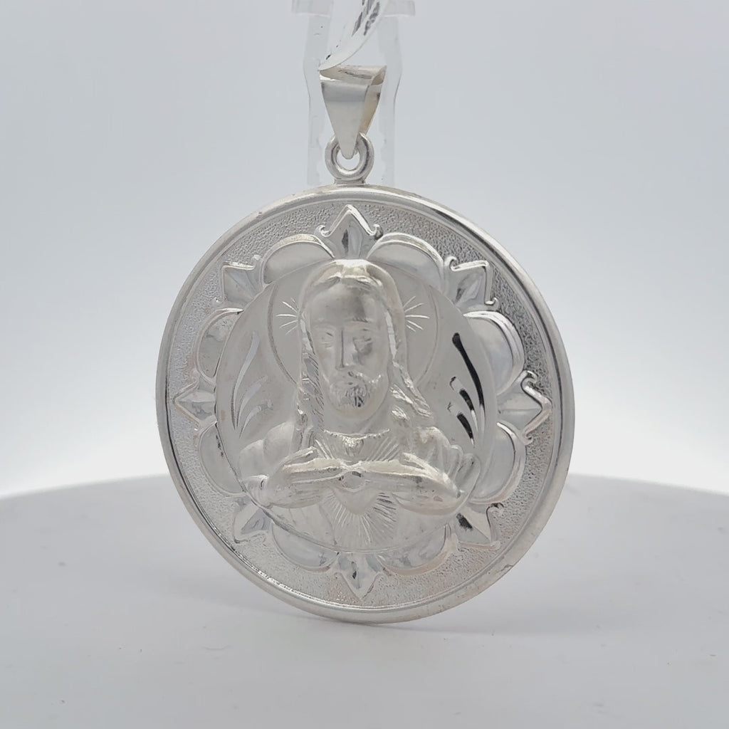 sterling silver double-sided Jesus and Virgin Mary medallion pendant showing Jesus with the Sacred Heart and a floral border