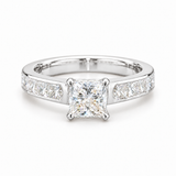 A princess cut diamond engagement ring with a channel set band featuring princess diamonds on either side.