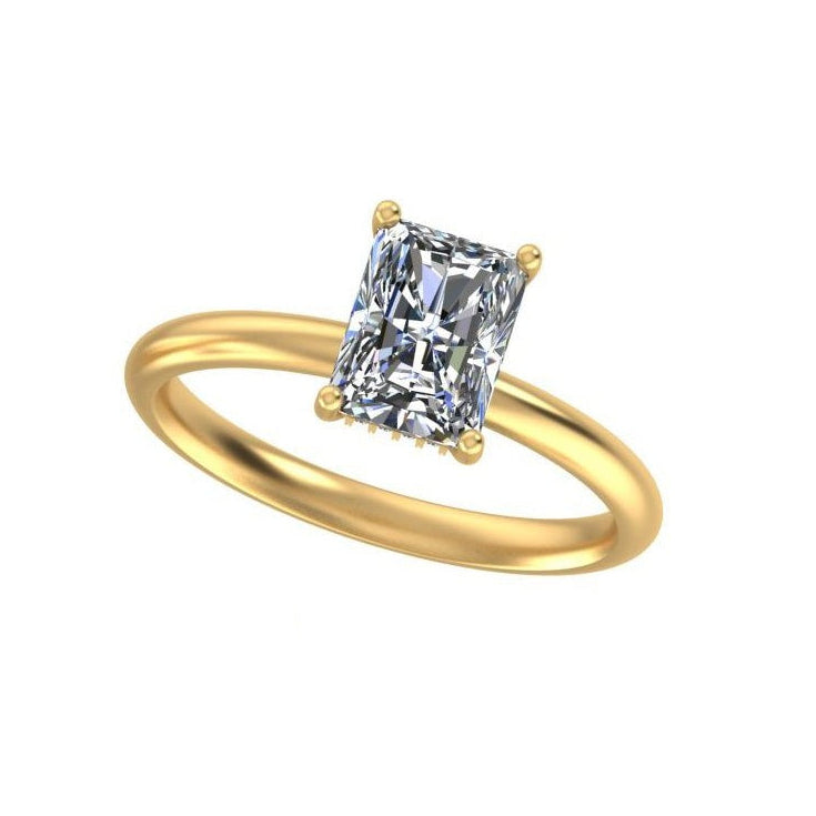 A yellow gold solitaire ring featuring a rectangular radiant-cut diamond, shown on a clean white background.