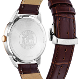 Watch with brown leather strap and silver case on a white background