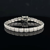 Discover a silver moissanite bracelet with square links, baguette centers and sparkling round accents. Shop statement jewelry at Solomon & Co.
