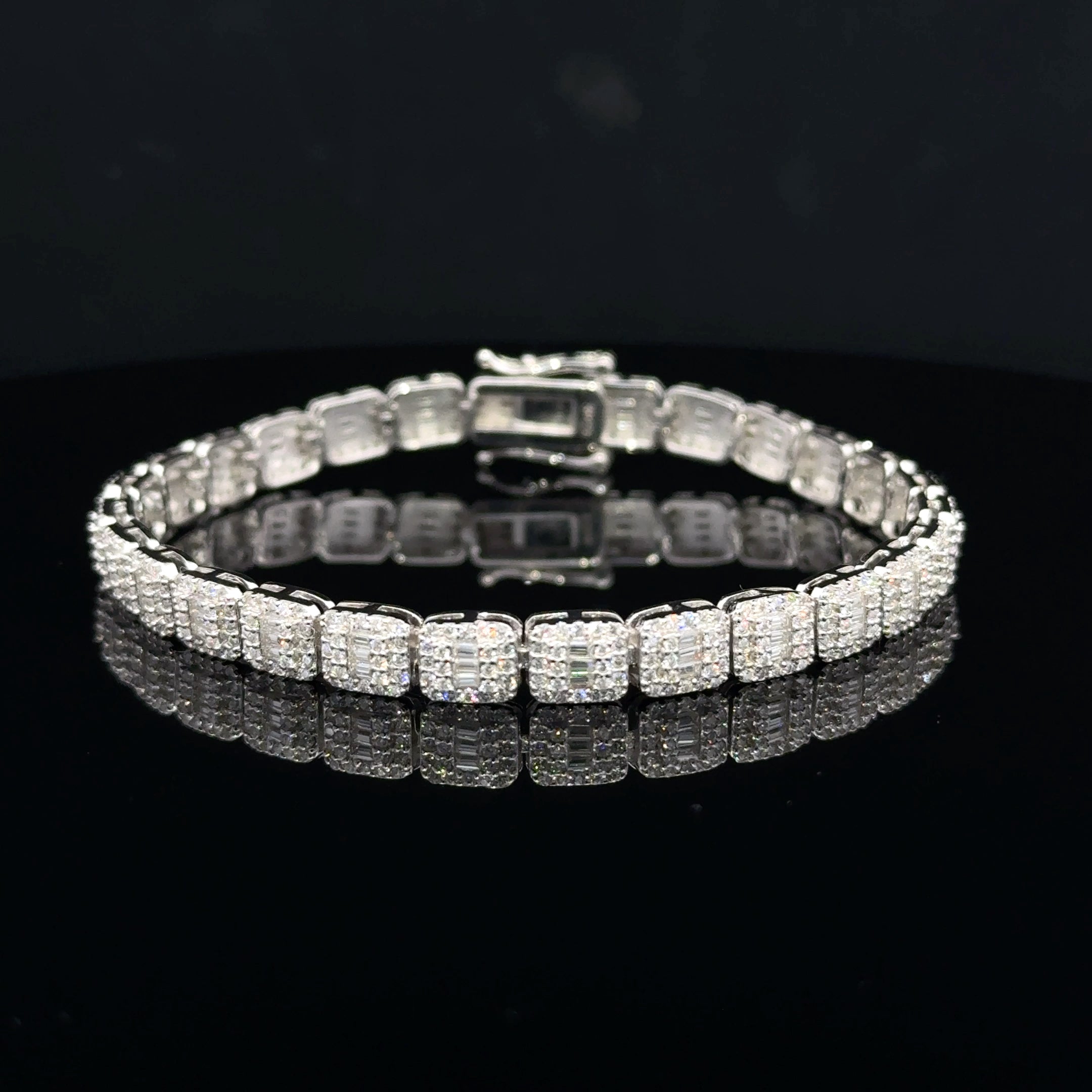 Discover a silver moissanite bracelet with square links, baguette centers and sparkling round accents. Shop statement jewelry at Solomon & Co.