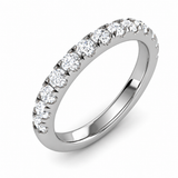 Slim polished silver wedding band with a row of round moissanite stones, shown at an angle on a white background.