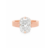 14K rose gold cushion cut solitaire diamond ring with hidden halo on a cigar band.