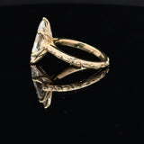 14K yellow gold ring featuring a Dutch marquise-cut lab-grown diamond in a six-prong setting with floral engraving and diamond accents with tulip basket.