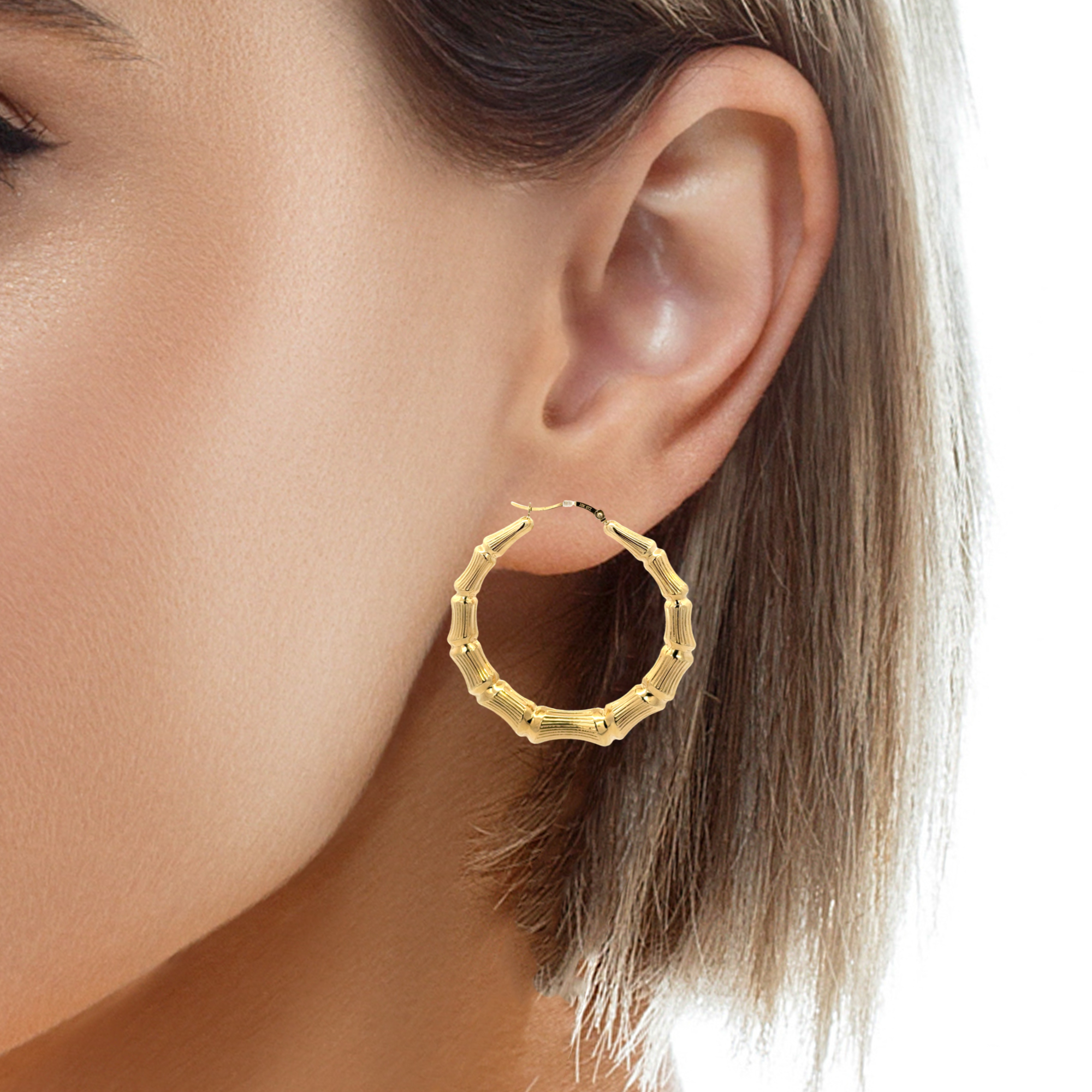Yellow gold bamboo hoop earrings for women with a lightweight hoop design from Solomon Jewelers