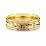  Yellow gold wedding band with engraved chevron pattern and milgrain edges on a white background